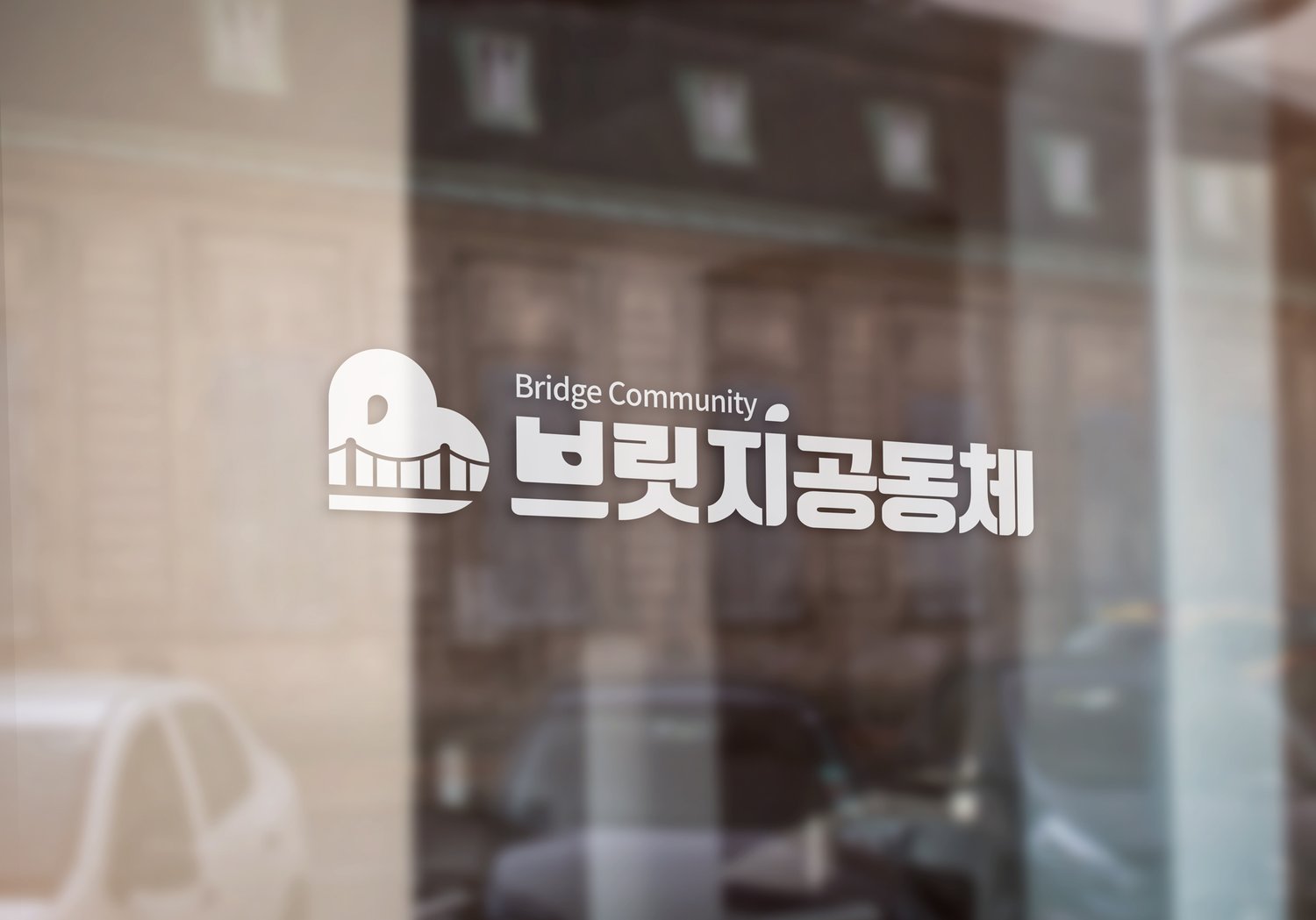 유리문 시트 — 국문 '브릿지공동체' 조합을 흰 한 색으로 뽑았습니다.